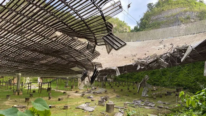 A view from below the collapsed dish of the Arecibo Observatory radio telescope.